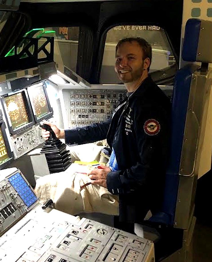 Aerospace enthusiast — flight jacket with squadron-style patch, shuttle cockpit exhibit